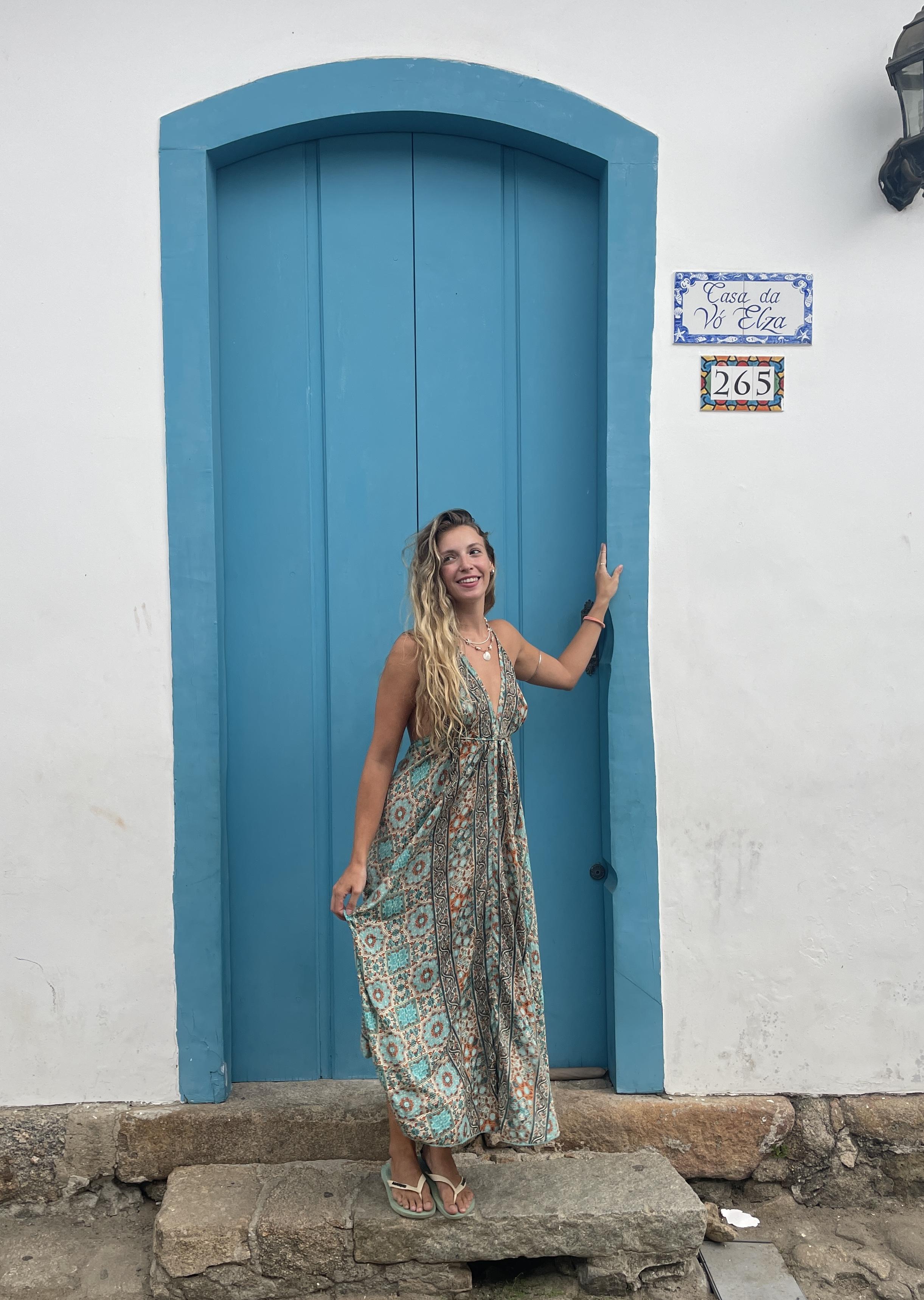 Inês in front of blue door